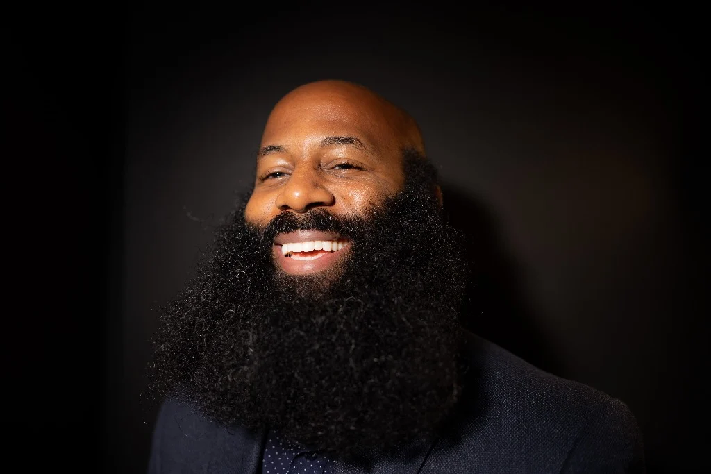 Anson laughing in the studio, full beard looking healthy and natural.
